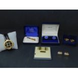 A collection of cufflinks, together with a tie clip and a watch