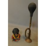 A novelty cast metal money box and a vintage brass car horn. L.47cm