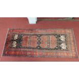 A north west Persian Malayer rug, the double pole medallion, on a terracotta ground, contained by