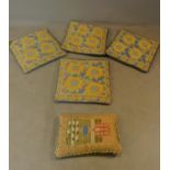 Four tapestry cushions (42x42cm) and a sampler style example.