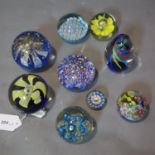 A collection of nine glass paperweights, to include millefiori examples, H.10cm (tallest)