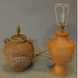 An urn shape terracotta lamp base and another similar. H.42cm (tallest)