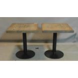 A pair of pub tables with square oak tops, raised on black steel bases, H.64 W.57 D.57cm