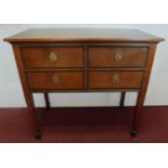 An early Victorian oak and ebonised side table fitted with 4 drawers. H.96 W.104 D.53cm