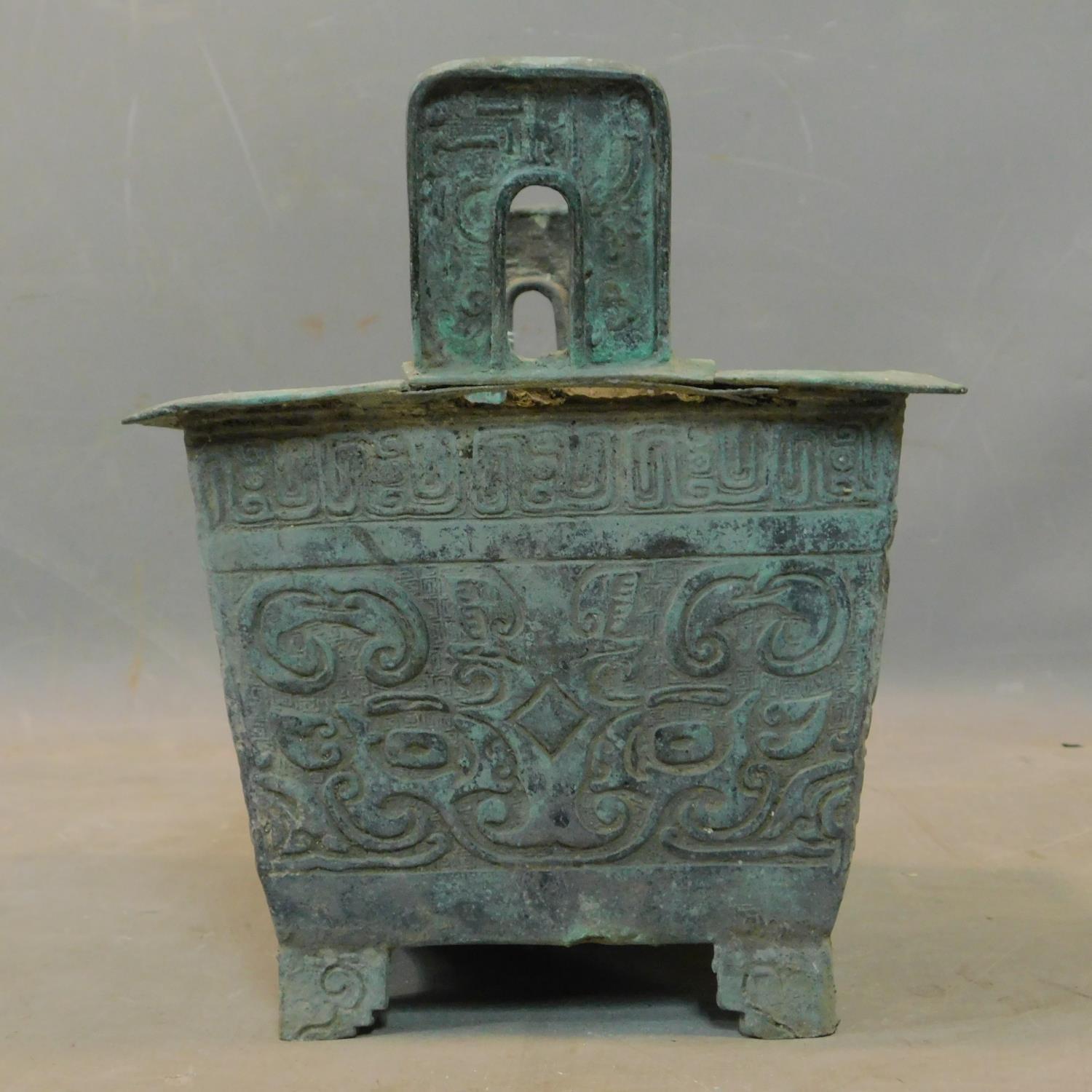 A Chinese archaic bronze incense burner, with twin handles and scrolling decoration, H.26 W.23 D. - Image 2 of 4