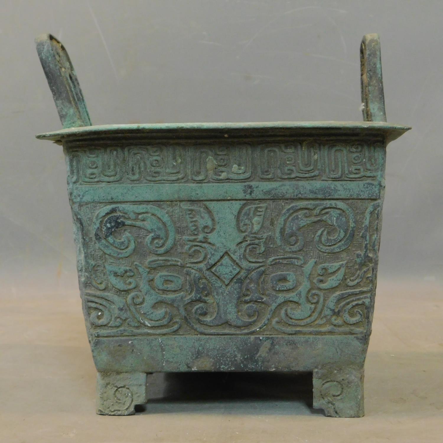 A Chinese archaic bronze incense burner, with twin handles and scrolling decoration, H.26 W.23 D. - Image 3 of 4