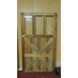 A large farmhouse style stained pine door with 3 glass panels, 210 x 114cm