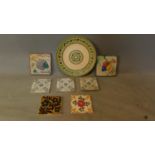 A decorative Crown Ducal wall plate (D.36cm) and a collection of decorative ceramic tiles. (8)