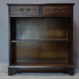 A 20th century inlaid mahogany bookcase with two short drawers above shelf and bracket feet, H.82