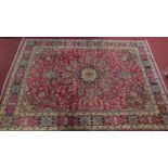 A large 20th century signed Mashad carpet, the central floral medallion surrounded by repeating