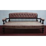 A late Victorian Aesthetic ebonised sofa on turned tapered supports, W.155 D.70cm