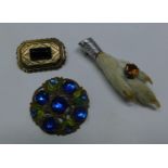 A collection of 3 brooches to include a 19th century French mourning brooch, a Scottish white