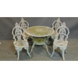 A vintage Coalbrookdale style white painted metal garden table and 4 matching chairs, stamped made