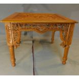 An Eastern carved teak centre table. H.75 W.100 D.100cm
