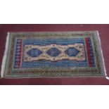 A vintage north west Persian Ardebil rug, with 3 geometric medallions, on a blue and beige ground,