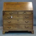 A 19th century oak bureau with marquetry inlay, raised on bracket feet, H.106 W.99 D.53cm