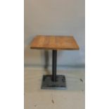 A Pedrali tilt top pub table with square oak top, raised on black steel base, H.76 W.65 D.65cm