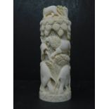 An early 20th century ivory carving decorated with elephants and lions, H.17cm