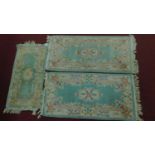 3 Chinese style floral rugs all set on a green field with central medallion within floral