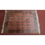 A bokhara rug on a rouge ground. L.268 W.190cm