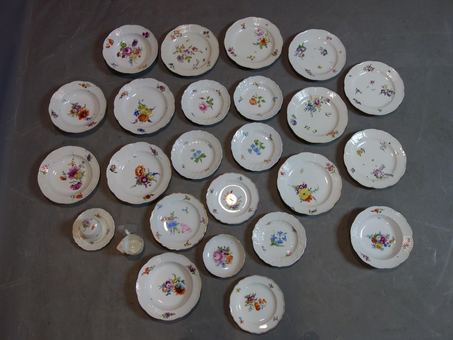 A collection of Meissen porcelain to include 23 plates, a cup and a sugar pot