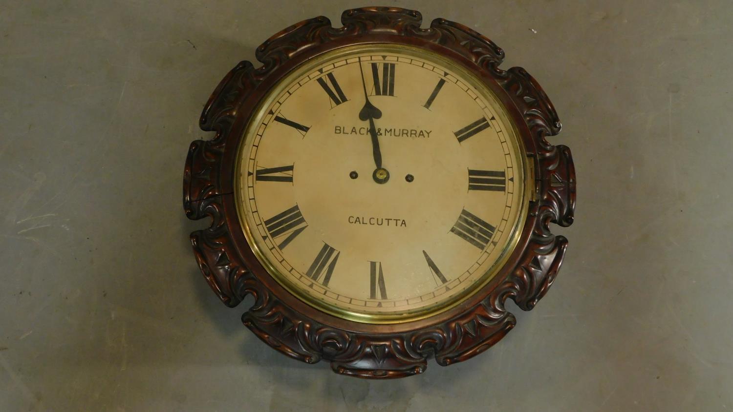 A 19th century carved mahogany cased wall clock, Black and Murray Calcutta H.43 W.43 D.18