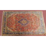 A north west Persian Sarouk rug, the central double pendant medallion with repeating petal motifs,