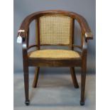 A mid 20th century caned teak tub chair, raised on tapered legs and spade feet, H.85 W.63cm