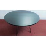 A contemporary designer circular table, lacquered top on hairpin supports. H.75 W.120cm