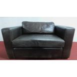 A small leather sofa H. 68cm W. 133cm