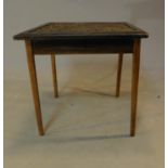 A carved top teak occasional table. H.49 W.53 D.55cm