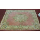 A large vintage Chinese woolen carpet, with floral design on a pink ground, 366 x 255cm