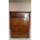 A Georgian mahogany and inlaid corner cupboard H.124 W.107 D.57cm