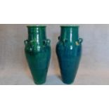 A pair of large green glazed sharab wine vessels H.90 W.40cm