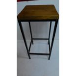 A tubular metal night table with solid teak top. 75x35cm.