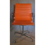A chrome framed swivel desk chair in orange vinyl upholstery. H.96 W.57 D.51cm