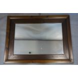 A stained pine mirror with bevelled plate, 90 x 121cm