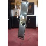 A wrought iron floor standing mirror with candle scones, H.160 W.37 D.62cm
