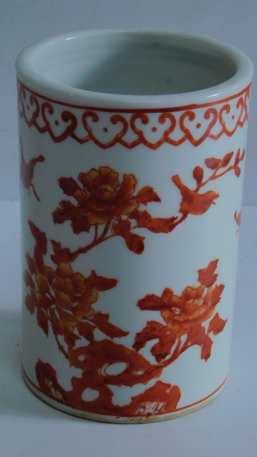 A mid 20th century Chinese brush pot decorated in iron red with butterflies and flower decoration,