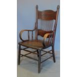 A late 19th century oak rustic press back armchair with scrolled arms. H.108 W.60 D.53cm