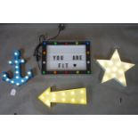 A light up sign together with a light up arrow, star and anchor
