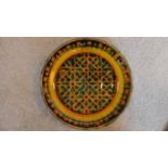 A Persian glazed ceramic bowl decorated in a geometric pattern, dated and marked to base. 7x28cm