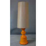 A 20th century orange glazed pottery lamp with shade, H.115cm