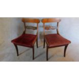 A pair of Regency mahogany and satinwood strung dining chairs on sabre supports. H.80 W.46 D.50cm (