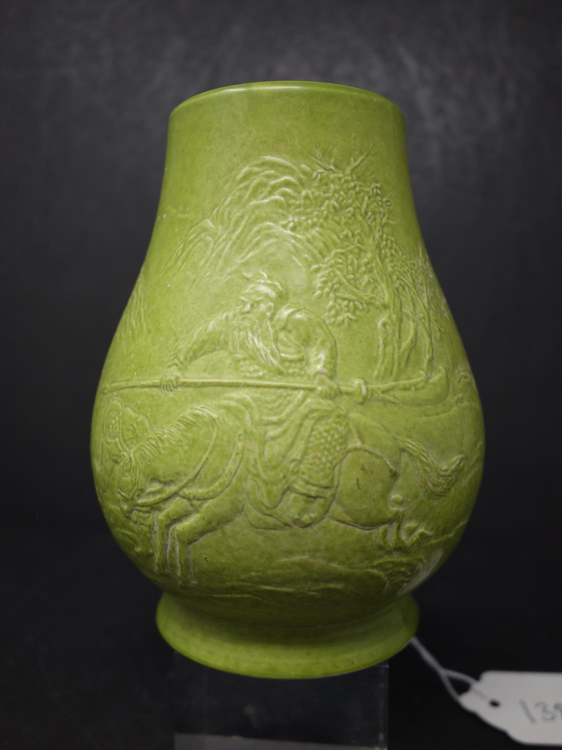 A green Chinese vase decorated with warrior on a horse and verse, seal mark to base reads Wang