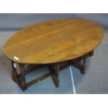 A low oak drop flap gateleg table, H.50 L.148cm