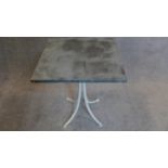 A painted metal garden table with pewter top. H.65 W.54cm