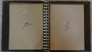 A folio containing 25 hand painted designs and patterns for jewellery. 23x9cm