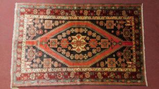 A Persian Zanjar rug, central double pendant medallion with repeating geometric border. 210x135cm.