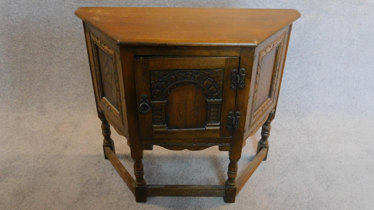 A small Jacobean style court cupboard fitted carved panel door. H.70 W.80 D.33cm